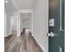 Long hallway with wood-look floors and a keyless entry system in a home with modern finishes at 609 Gryffindor Dr., Longs, SC 29568