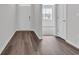 Hallway view featuring wood flooring, white trim and doors with access to rooms with natural light at 609 Gryffindor Dr., Longs, SC 29568