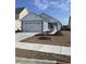 Charming single-story home with light blue siding, a two-car garage, and a well-manicured front yard at 615 Castle Ct., Myrtle Beach, SC 29579