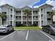 Condo building featuring multiple units and balconies, lush landscaping, and convenient parking spaces at 637 Waterway Village Blvd. # 13-E, Myrtle Beach, SC 29579