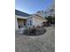 Exterior view showcasing the manicured lawn, patio, and neutral siding of this well-maintained home at 672 Pinehurst Ln. # 81D, Pawleys Island, SC 29585