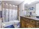 Well-lit bathroom features a decorative vanity, bath tub with shower, nautical décor, and ample storage at 7603 N Ocean Blvd. # 4E, Myrtle Beach, SC 29572