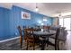 Stylish dining room with blue walls, a wooden table, and comfortable seating at 7603 N Ocean Blvd. # 4E, Myrtle Beach, SC 29572