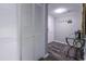 Hallway featuring a mirrored closet and a decorated console table with a 'Sandy Feet Welcome' sign at 7603 N Ocean Blvd. # 4E, Myrtle Beach, SC 29572