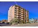 Exterior view of condo building with balconies, landscaping, and parking at 7603 N Ocean Blvd. # 4E, Myrtle Beach, SC 29572