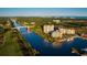 Panoramic aerial view featuring a waterway, golf course, bridge, and nearby coastal buildings at 8155 Living Tide Dr., Myrtle Beach, SC 29572