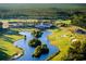 Wide aerial view of the golf course with clubhouse, winding waterways, and lush landscaping at 8155 Living Tide Dr., Myrtle Beach, SC 29572