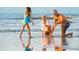 A Gathering enjoys the shallow surf on a sunny beach at 8155 Living Tide Dr., Myrtle Beach, SC 29572