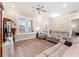 Bright living room with hardwood floors, neutral paint, large windows and comfortable seating at 8155 Living Tide Dr., Myrtle Beach, SC 29572