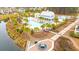 Aerial view of a community pool with palm trees and lounge chairs, perfect for relaxation at 8155 Living Tide Dr., Myrtle Beach, SC 29572