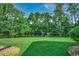 Backyard featuring lush green grass, a tranquil pond, and mature trees at 8545 Hopkins Circle # G, Myrtle Beach, SC 29575