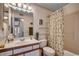 Well-lit bathroom featuring a vanity, toilet, and shower-tub combo with floral shower curtain at 8545 Hopkins Circle # G, Myrtle Beach, SC 29575
