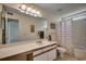 Bathroom featuring a long countertop, white cabinets, and a shower with a patterned curtain at 8545 Hopkins Circle # G, Myrtle Beach, SC 29575