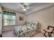 Cozy bedroom featuring a comfortable bed, ceiling fan, and a window with plenty of natural light at 8545 Hopkins Circle # G, Myrtle Beach, SC 29575