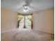 Sunlit bedroom featuring a ceiling fan and windows offering natural light at 8545 Hopkins Circle # G, Myrtle Beach, SC 29575