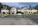 Spacious condo building exterior with ample parking and sidewalk entrance at 8545 Hopkins Circle # G, Myrtle Beach, SC 29575