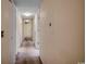 Hallway with neutral walls and carpet, showcasing the home's layout and transition between rooms at 8545 Hopkins Circle # G, Myrtle Beach, SC 29575