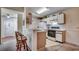 Cozy kitchen featuring white cabinets, bar seating, and ample countertop space at 8545 Hopkins Circle # G, Myrtle Beach, SC 29575