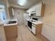 Efficient kitchen featuring laminate counters and updated white appliances creating a modern and functional space at 8545 Hopkins Circle # G, Myrtle Beach, SC 29575