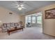 Cozy living room with neutral walls, carpet, and a sunroom providing ample light at 8545 Hopkins Circle # G, Myrtle Beach, SC 29575