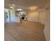 Open living space with bar top, modern light fixture, and a kitchen leading into the area at 8545 Hopkins Circle # G, Myrtle Beach, SC 29575