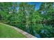 Scenic pond surrounded by lush greenery and a wooden walkway at 8545 Hopkins Circle # G, Myrtle Beach, SC 29575