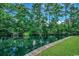 Pond view featuring lush green grass, a tranquil pond, mature trees and a boardwalk at 8545 Hopkins Circle # G, Myrtle Beach, SC 29575