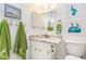 Clean white bathroom with speckled granite sink top and numbered green towels hanging on the wall at 88 Salt Marsh Circle # 22C, Pawleys Island, SC 29585