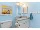 Light blue bathroom featuring a granite countertop, vanity with white cabinets, and beach themed artwork at 88 Salt Marsh Circle # 22C, Pawleys Island, SC 29585