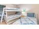 Shared bedroom featuring bunk beds with blue and white quilts and a bedside table with lighting at 88 Salt Marsh Circle # 22C, Pawleys Island, SC 29585