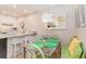 Bright dining area with a glass table, seating for six, and an adjacent kitchen counter at 88 Salt Marsh Circle # 22C, Pawleys Island, SC 29585