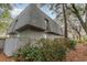 Exterior view of grey home surrounded by trees at 88 Salt Marsh Circle # 22C, Pawleys Island, SC 29585