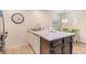 Kitchen island features granite countertops, dark wood cabinetry, and space for dining at 88 Salt Marsh Circle # 22C, Pawleys Island, SC 29585