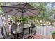 Outdoor patio under a large umbrella surrounded by trees and lush landscaping in a quiet neighborhood at 88 Salt Marsh Circle # 22C, Pawleys Island, SC 29585