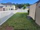 Large backyard with white fence, green lawn, and storage shed at 920 Leather Leaf Ln., Longs, SC 29568