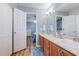 Bathroom features double sinks with wood cabinets, and leads into the bedroom for added convenience at 920 Leather Leaf Ln., Longs, SC 29568