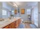 Bright bathroom with dual sinks, wood cabinets, and large mirror at 920 Leather Leaf Ln., Longs, SC 29568