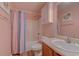 Cozy bathroom with single vanity and a shower with floral patterned shower curtain at 920 Leather Leaf Ln., Longs, SC 29568