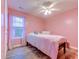 Cozy bedroom with a soft pink palette, complemented by wood flooring and bright natural light at 920 Leather Leaf Ln., Longs, SC 29568