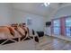 Cozy bedroom features a ceiling fan, wood-look flooring, and a window with privacy blinds at 920 Leather Leaf Ln., Longs, SC 29568