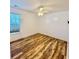 Bright bedroom with wood look floors, ceiling fan, and window for natural light at 920 Leather Leaf Ln., Longs, SC 29568