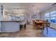 Dining room and kitchen space featuring wood floors, island with seating, and modern chandelier at 920 Leather Leaf Ln., Longs, SC 29568