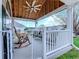 Cozy covered front porch with a rocking chair, outdoor seating, and white picket fence at 920 Leather Leaf Ln., Longs, SC 29568