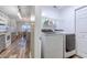 Modern laundry room adjacent to kitchen with washer and dryer at 920 Leather Leaf Ln., Longs, SC 29568