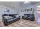 Comfortable living room featuring dual sofas, hardwood flooring, and ample natural light at 920 Leather Leaf Ln., Longs, SC 29568