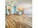 Spacious open-concept living area with beautiful wood floors and updated light fixtures, creating an inviting atmosphere at 920 Leather Leaf Ln., Longs, SC 29568