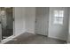 Bright living room with a sliding glass door, white walls, and large window at 920 Leather Leaf Ln., Longs, SC 29568