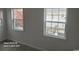 Bright living room with two windows offering views of the backyard at 920 Leather Leaf Ln., Longs, SC 29568
