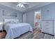 Cozy primary bedroom features a tray ceiling, ceiling fan, and ensuite bathroom access at 920 Leather Leaf Ln., Longs, SC 29568