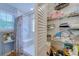 Bright bathroom with shower, linen closet filled with supplies and personal care items at 920 Leather Leaf Ln., Longs, SC 29568